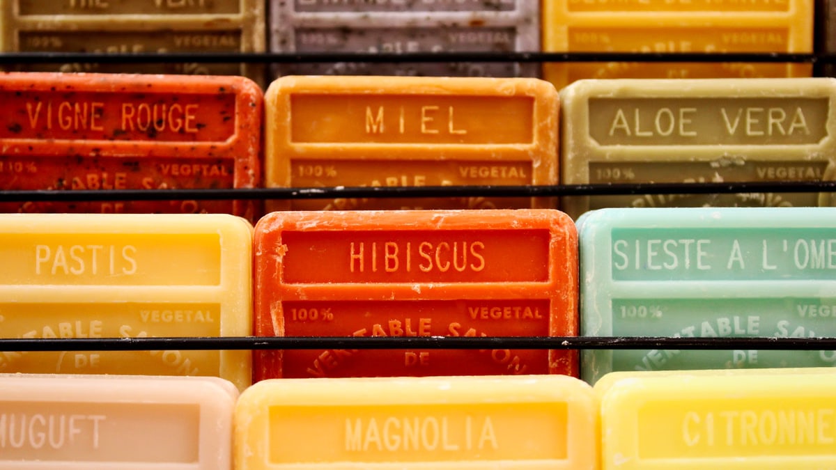 Colorful display of handmade aromatherapy soaps in various scents.